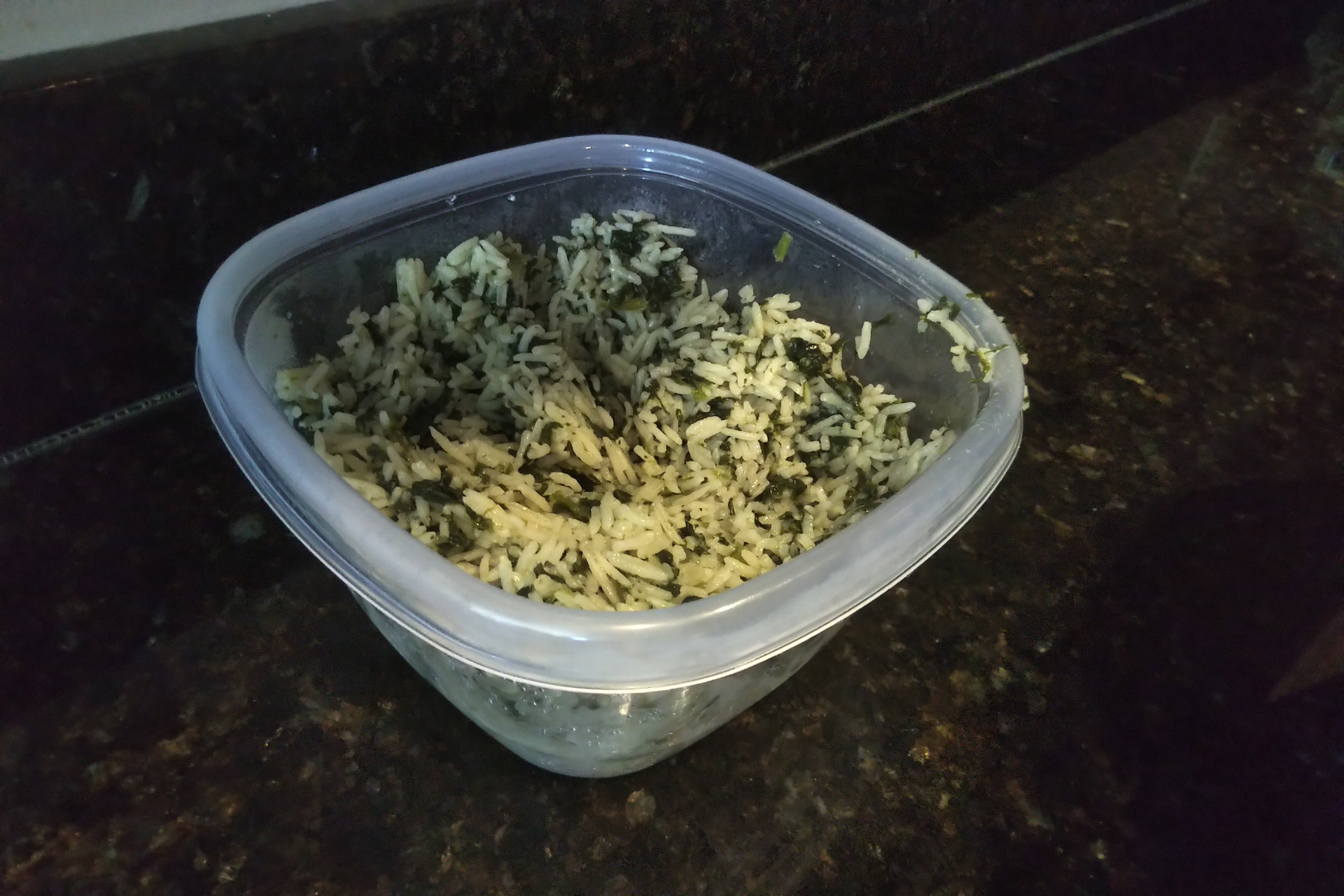 Picture of a container of rice with spinach