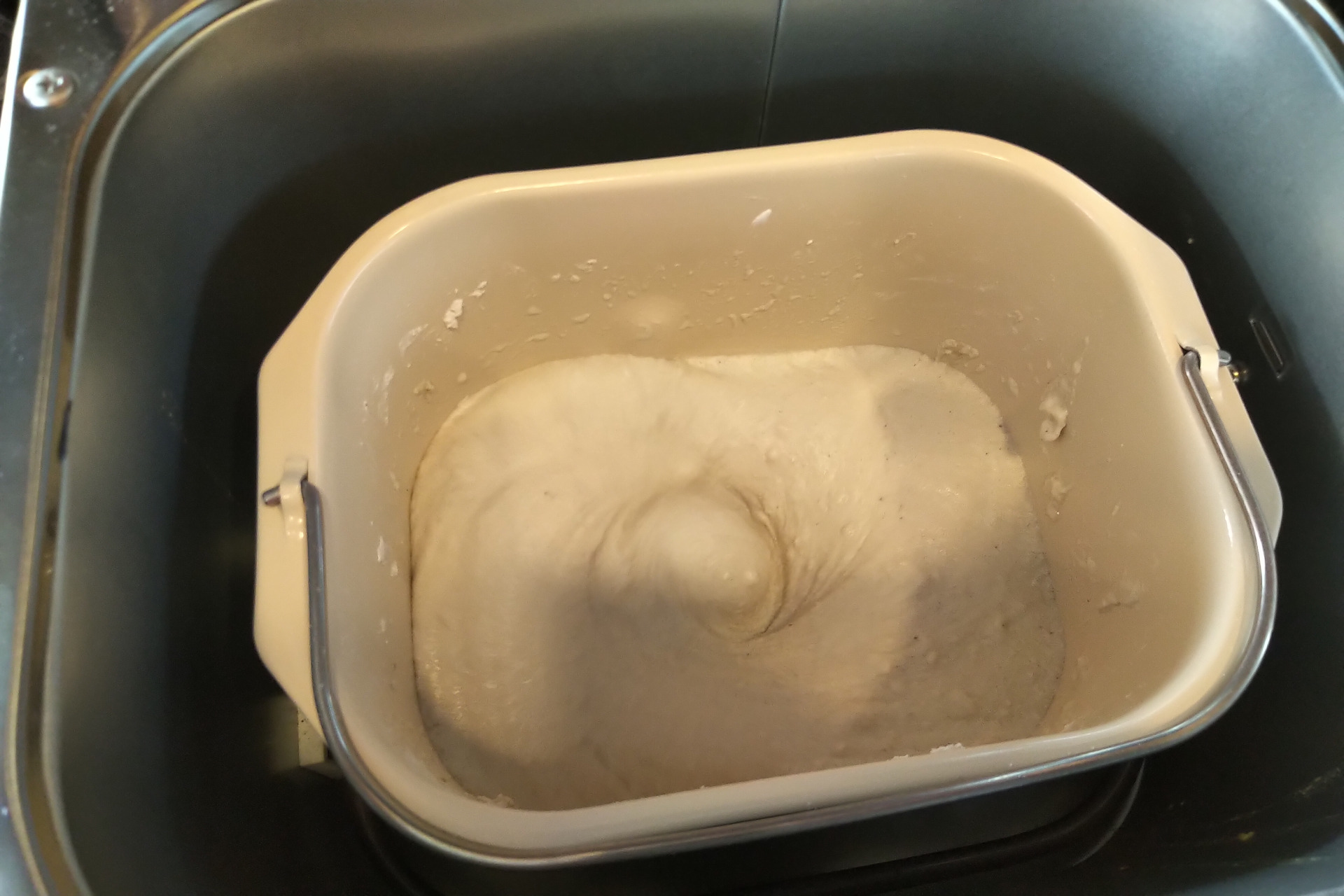 Bread machine showing mixed gluten free bread dough