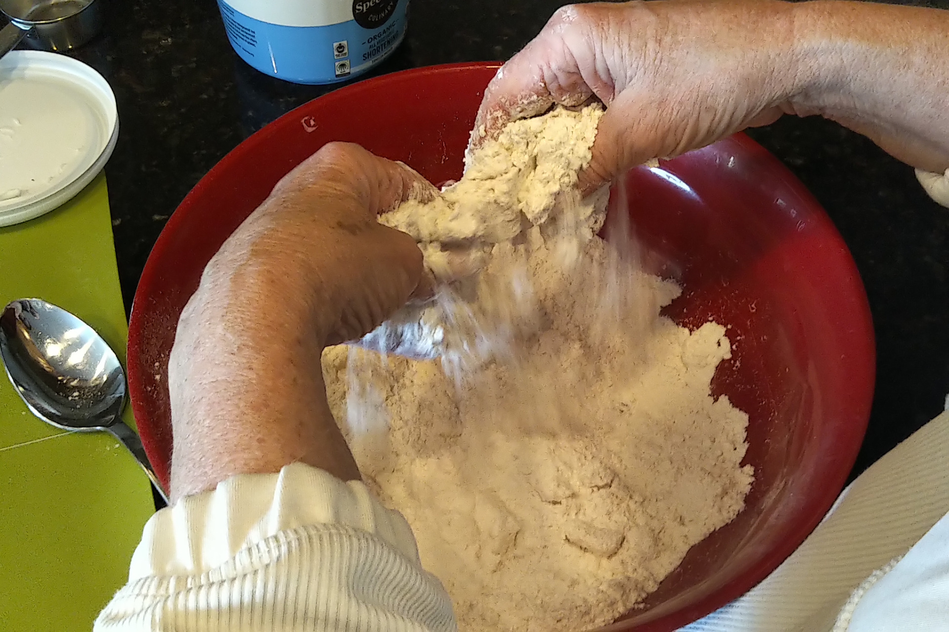 Showing squishing the shortening and flour together