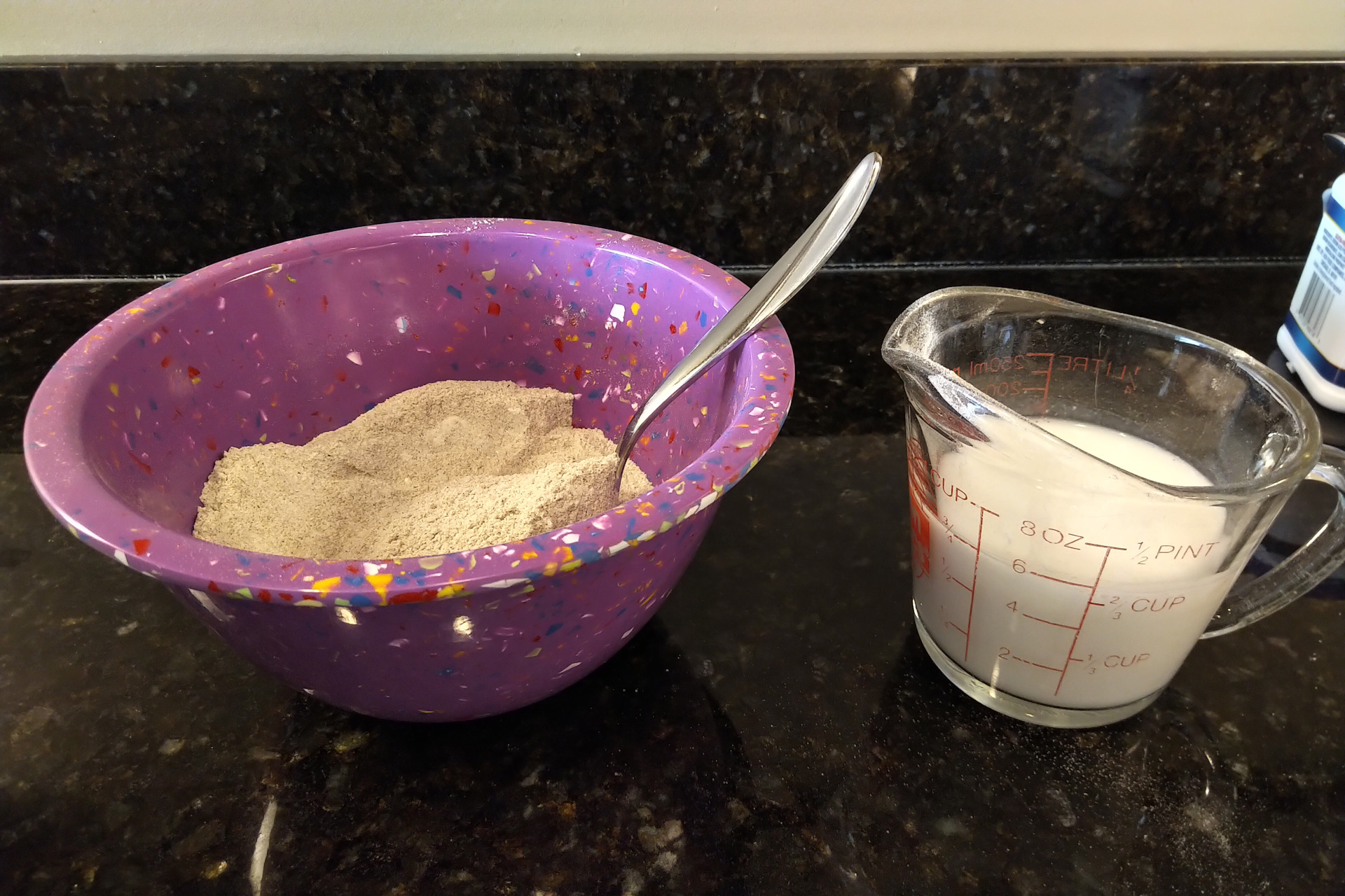 Dry ingredients next to measuring cup of coconut milk