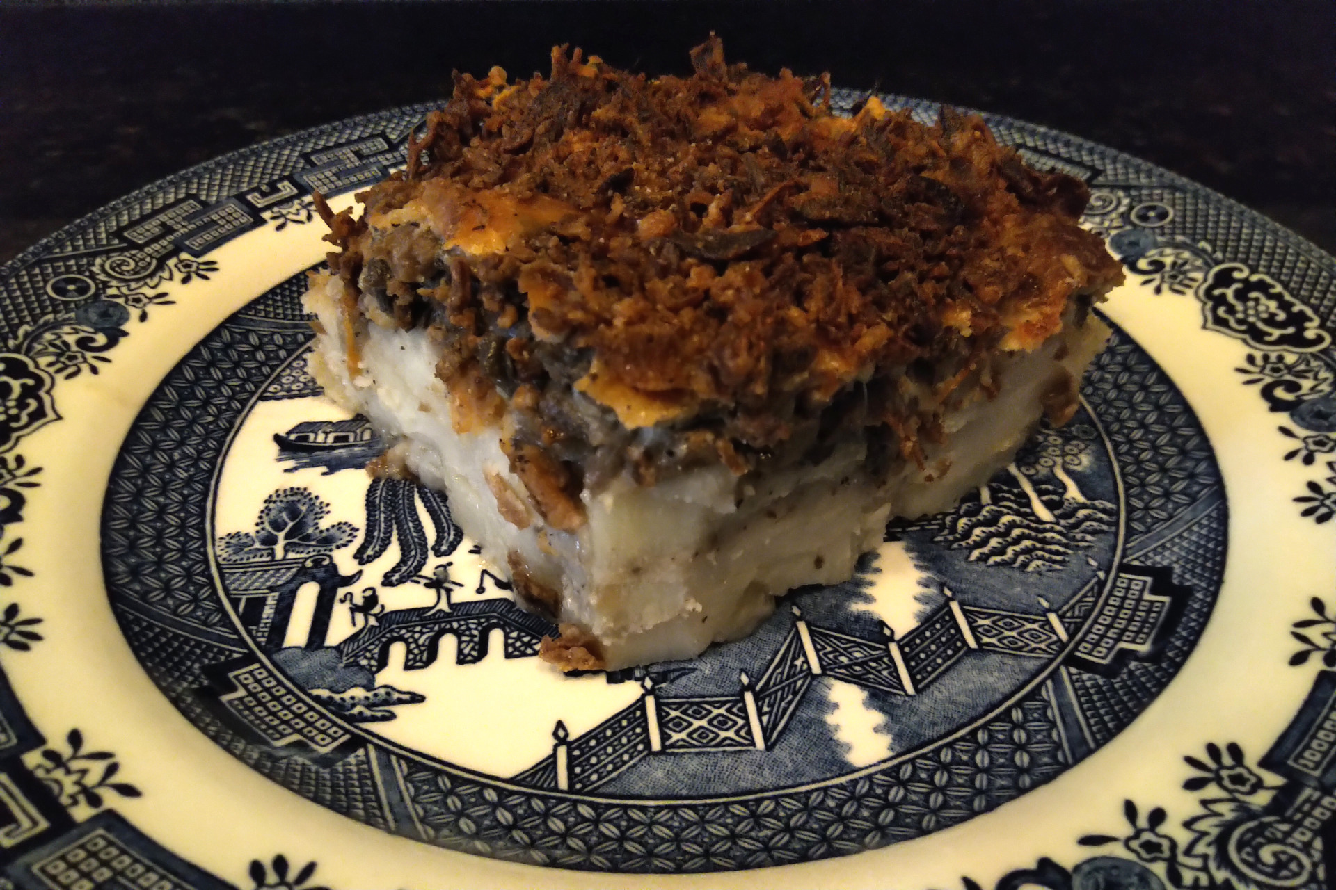 A piece of potato mushroom casserole on a plate